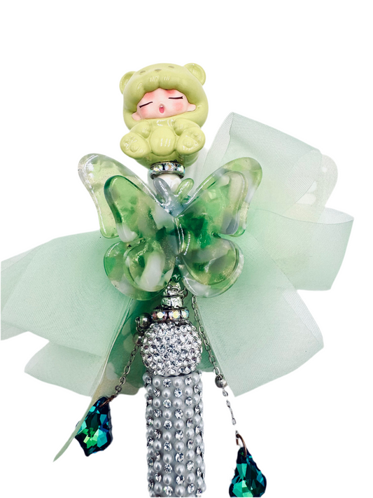 Green sleeping baby with butterfly charmed pen